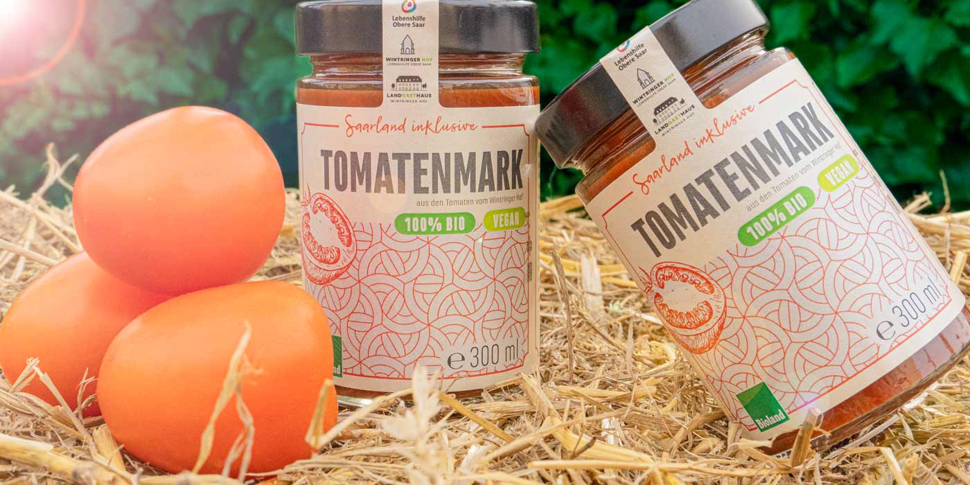 Zwei Gläser des Saarland inklusive-Tomatenmark auf einem Strohballen